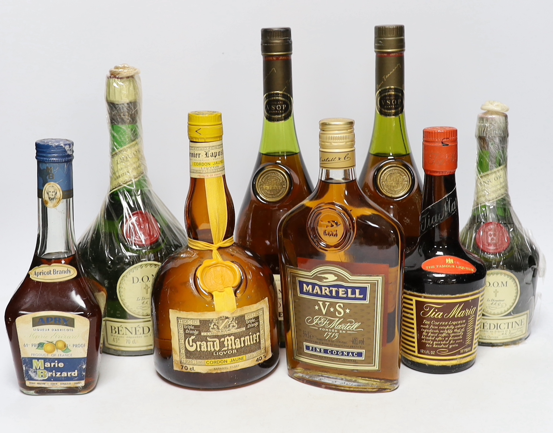 A bottle of Harrods Whisky, 12 years old, two bottles of Janneau VSOP Grand Armagnac, a bottle of Grand Marnier Cordon Jaune, one and a half bottles of D.O.M Benedictine, half a bottle of Martell V.S Fine Connacht, a bot